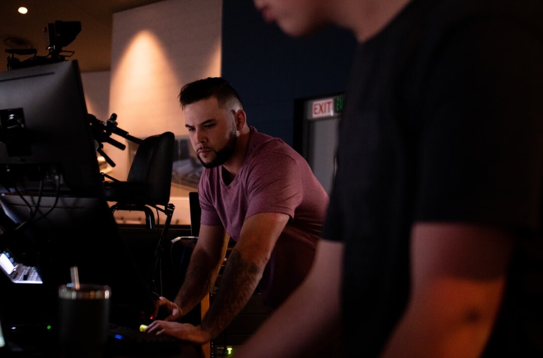 Trainer explaining live broadcast production to attentive trainees in a studio